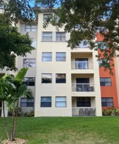 a view of a building with a yard