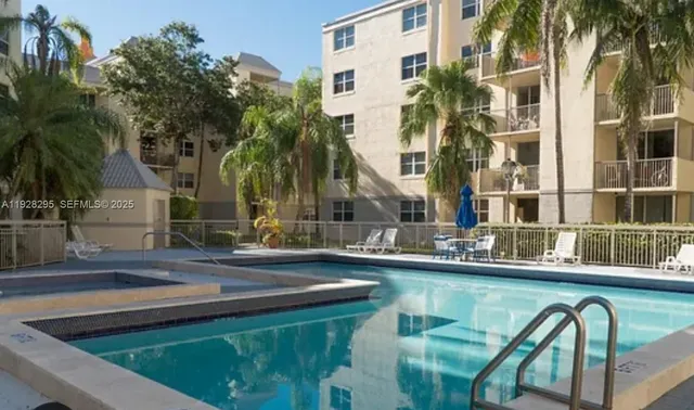 a swimming pool with outdoor seating and yard