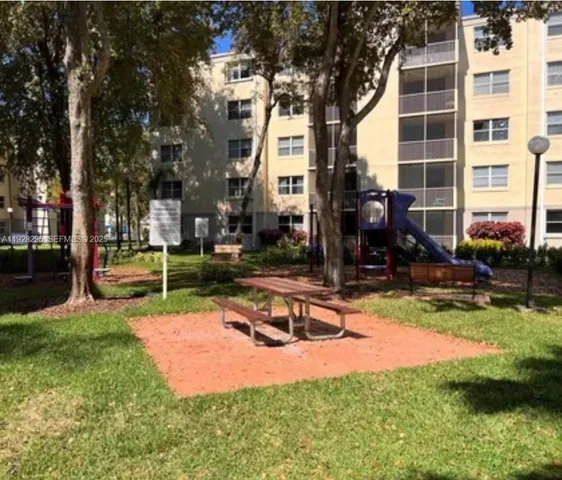 a view of a house with swimming pool and sitting area