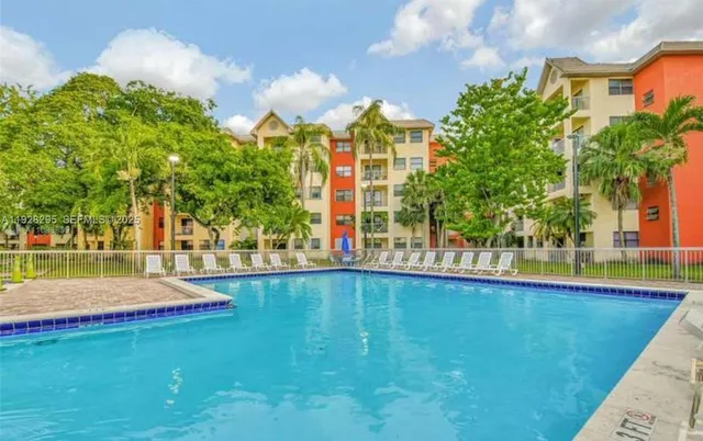 a view of a swimming pool with a yard