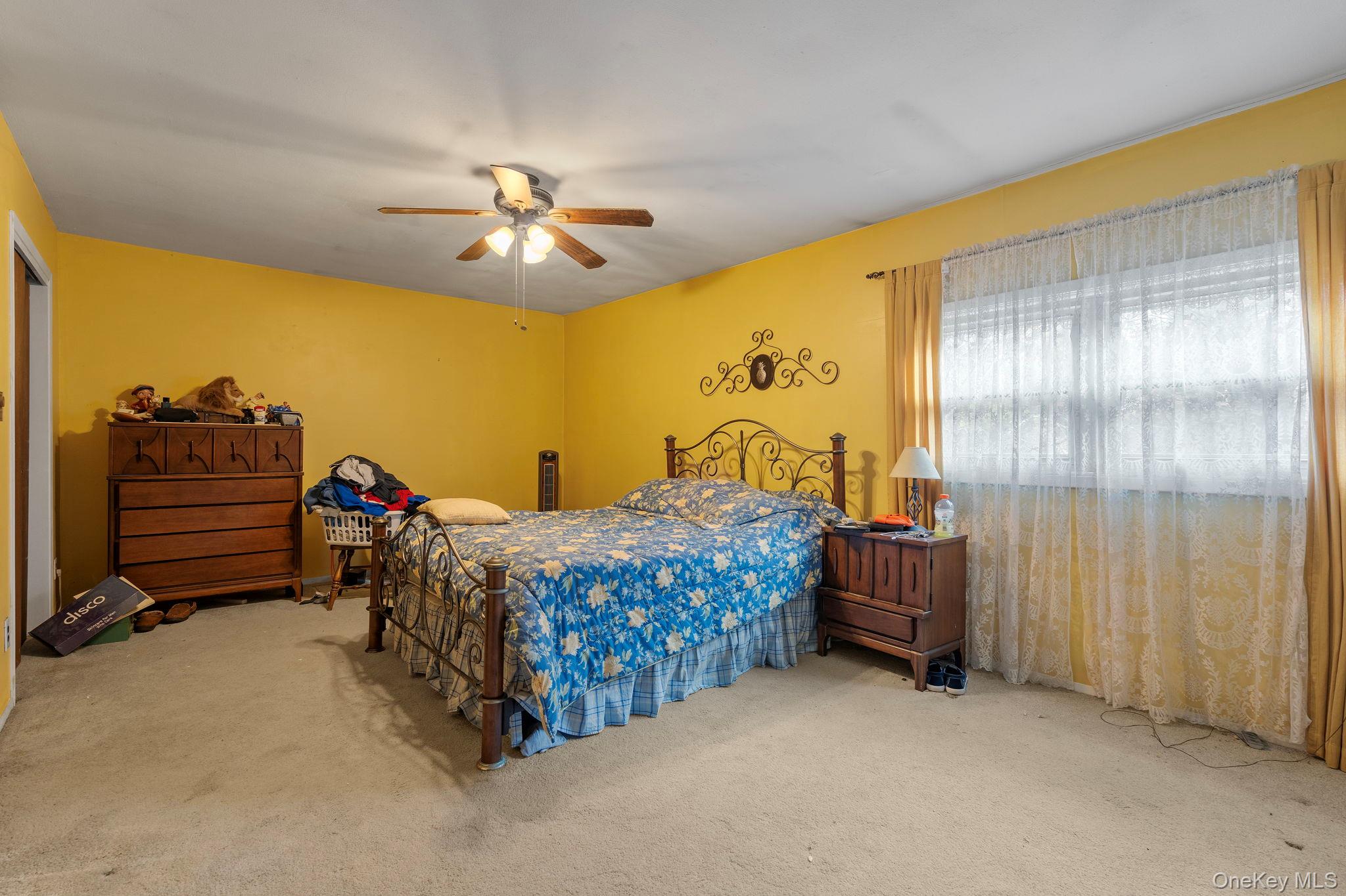 24 Russet Road Poughkeepsie, NY 12601 - Photo 14 of 26 a bed room with a bed and a ceiling fan