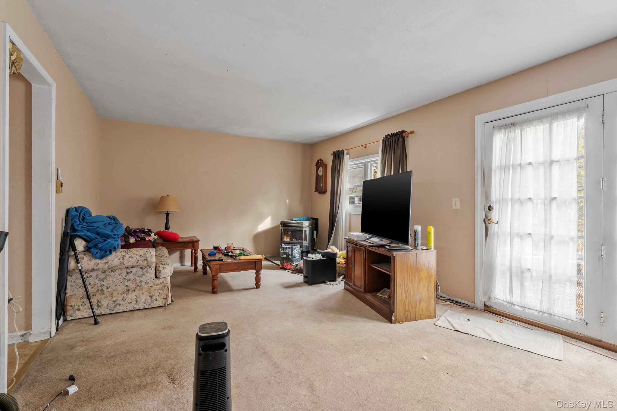 24 Russet Road Poughkeepsie, NY 12601 - Photo 2 of 26 a living room with furniture and a flat screen tv