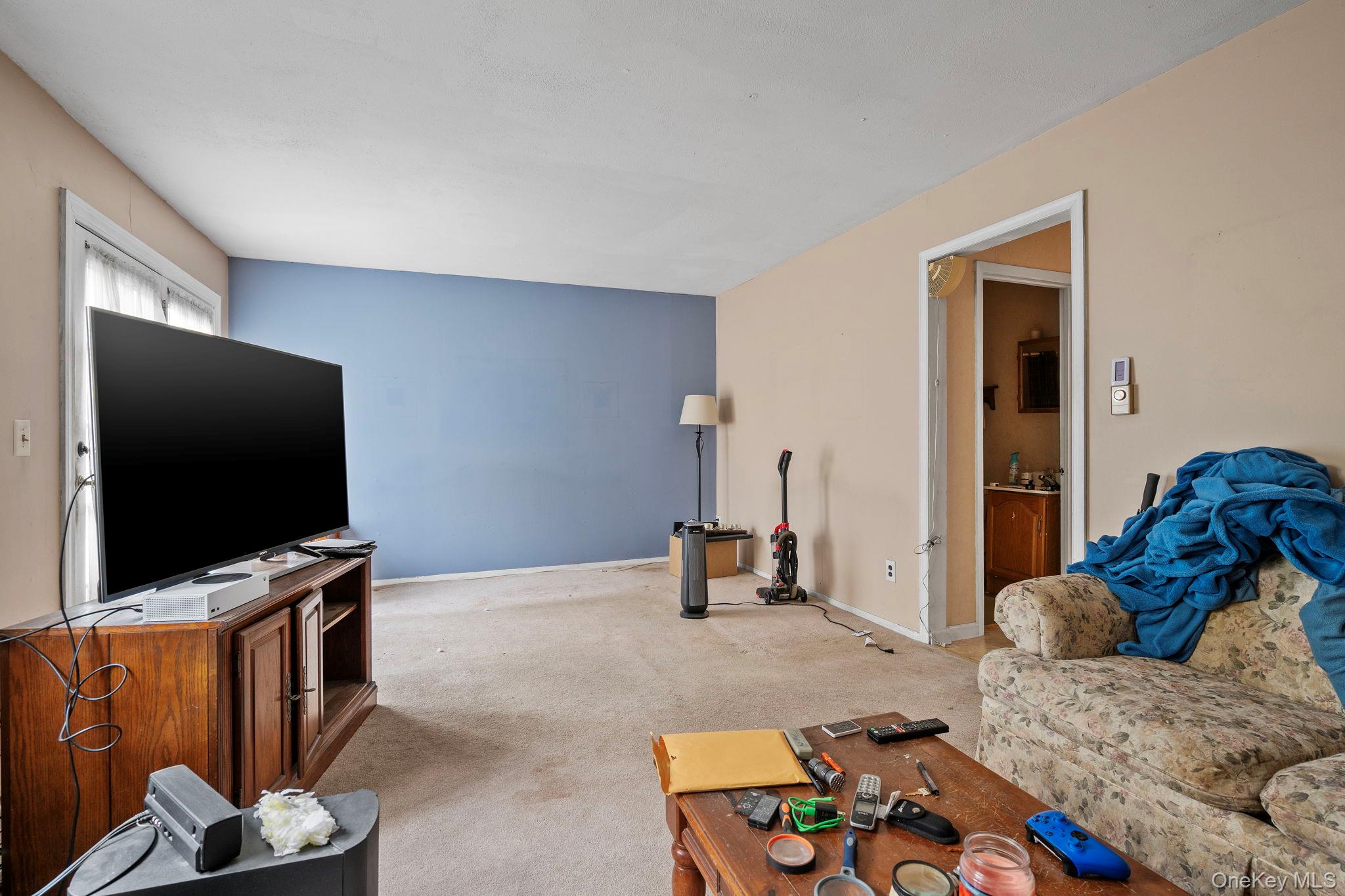 24 Russet Road Poughkeepsie, NY 12601 - Photo 4 of 26 a living room with furniture and a flat screen tv