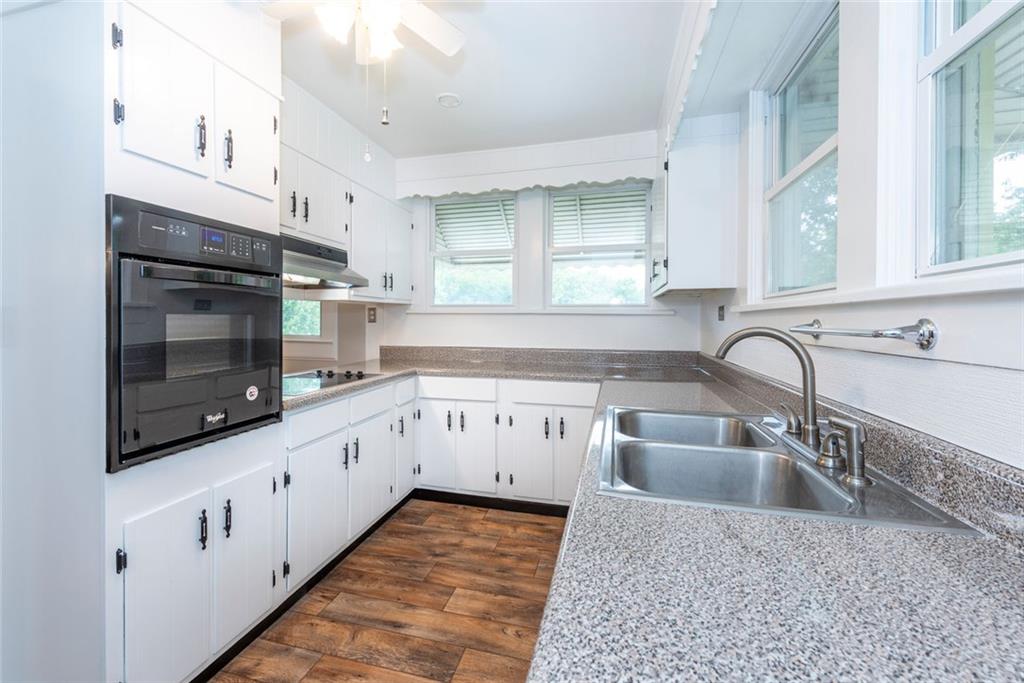 2508 Maple Road Southeast Rome, GA 30161 - Photo 13 of 55 a kitchen with granite countertop a sink stainless steel appliances and cabinets