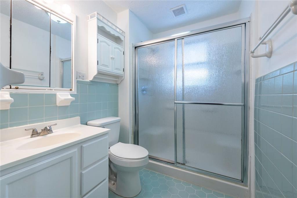 2508 Maple Road Southeast Rome, GA 30161 - Photo 21 of 55 a bathroom with a shower sink vanity and toilet