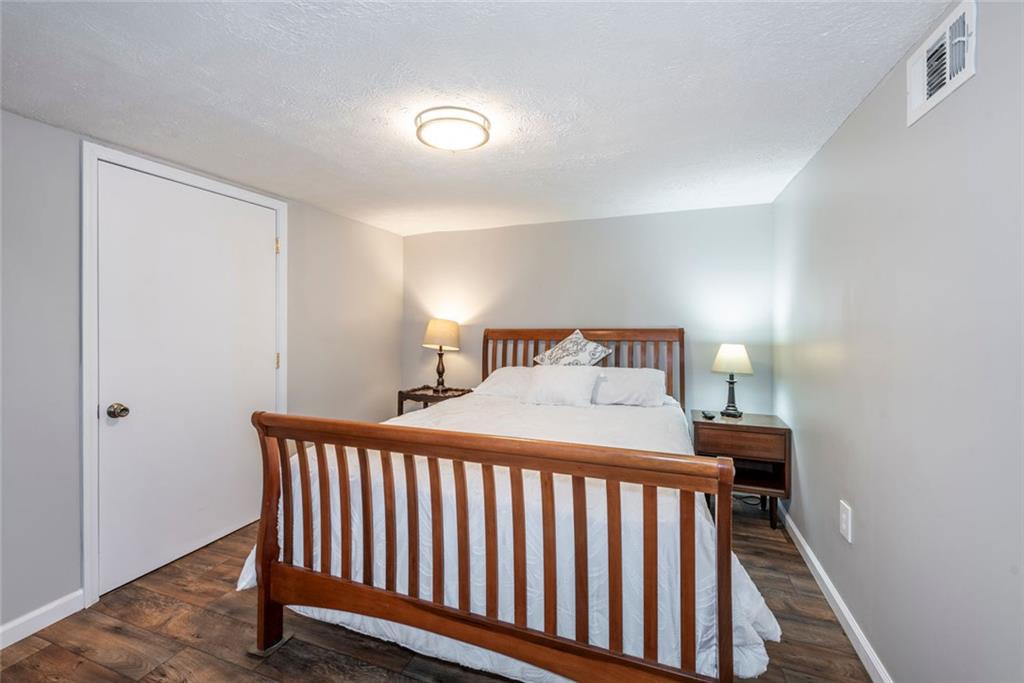 2508 Maple Road Southeast Rome, GA 30161 - Photo 30 of 55 a bedroom with a bed and wooden floor