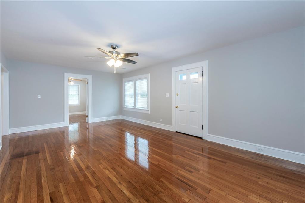 2508 Maple Road Southeast Rome, GA 30161 - Photo 7 of 55 a view of an empty room with window and wooden floor