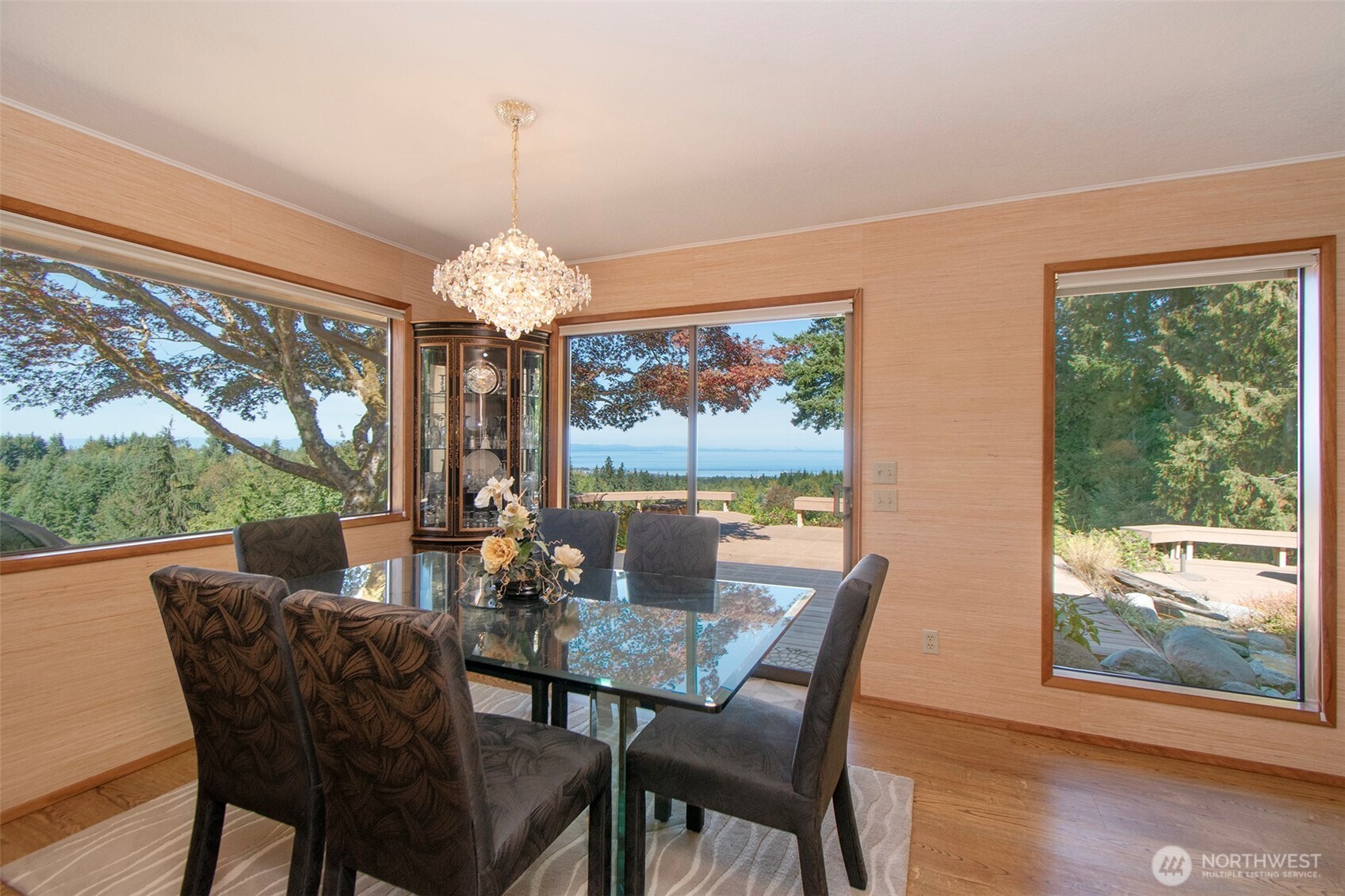 5418 South Old Mill Road Port Angeles, WA 98362 - Photo 12 of 39 a dining room with furniture a chandelier and wooden floor