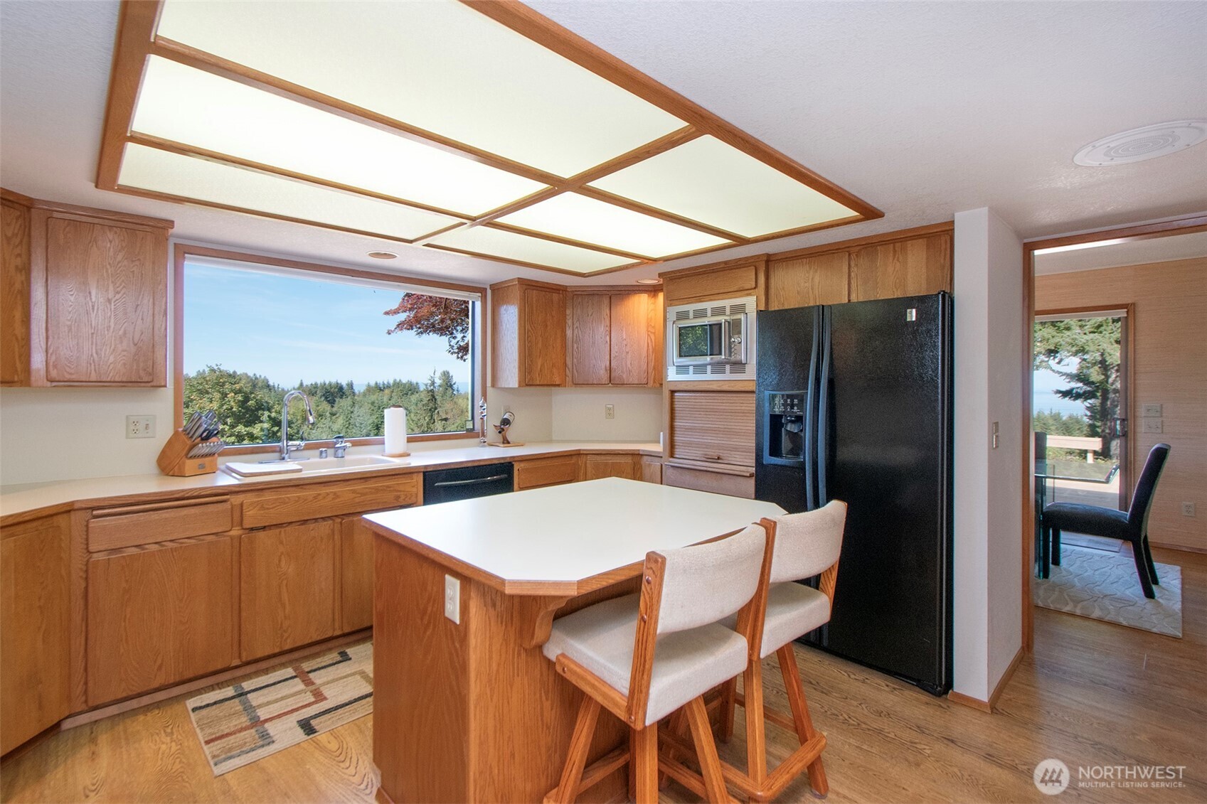 5418 South Old Mill Road Port Angeles, WA 98362 - Photo 14 of 39 a kitchen with stainless steel appliances a refrigerator a table and chairs