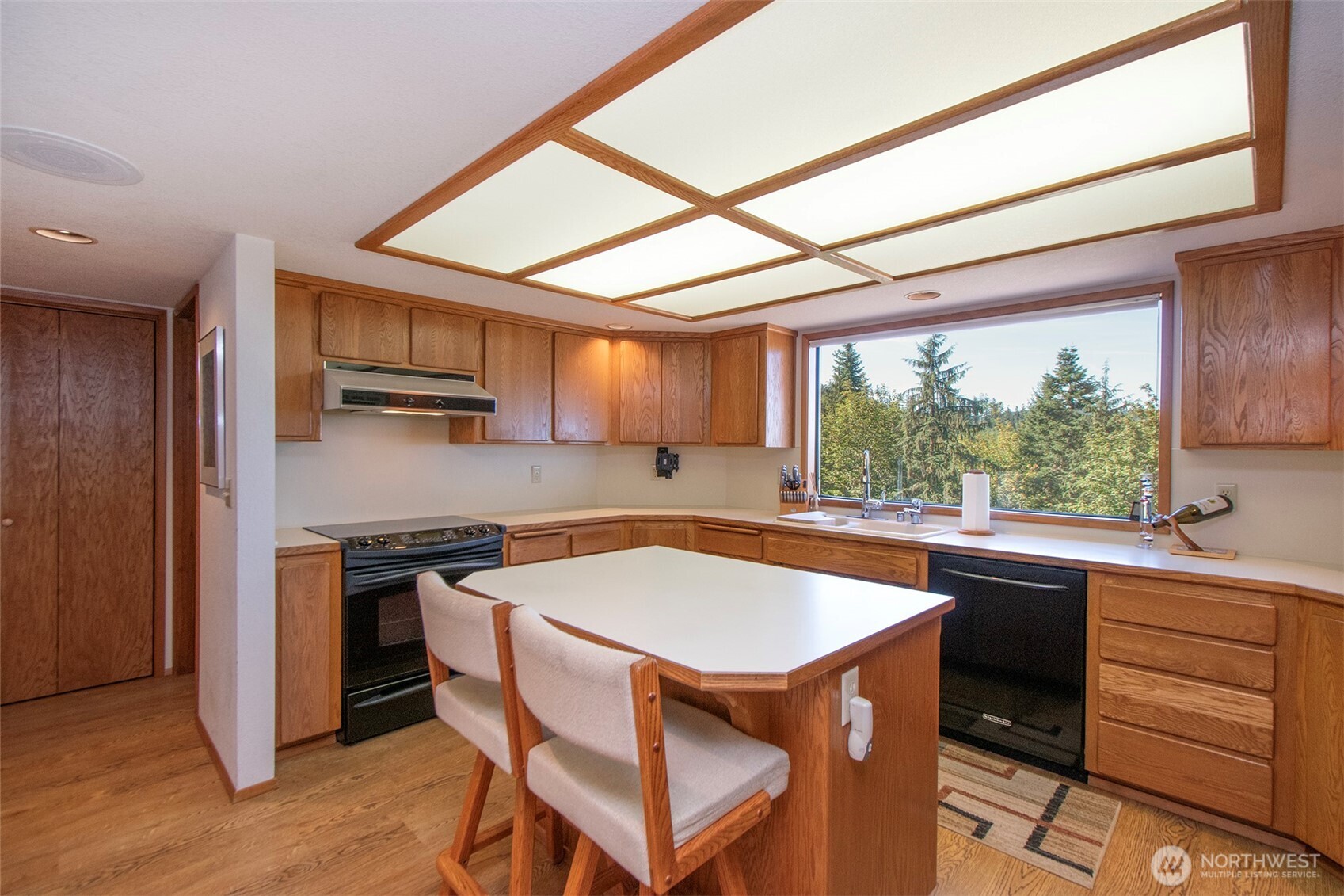 5418 South Old Mill Road Port Angeles, WA 98362 - Photo 15 of 39 a kitchen with stainless steel appliances granite countertop a stove a refrigerator and a sink with wooden cabinets