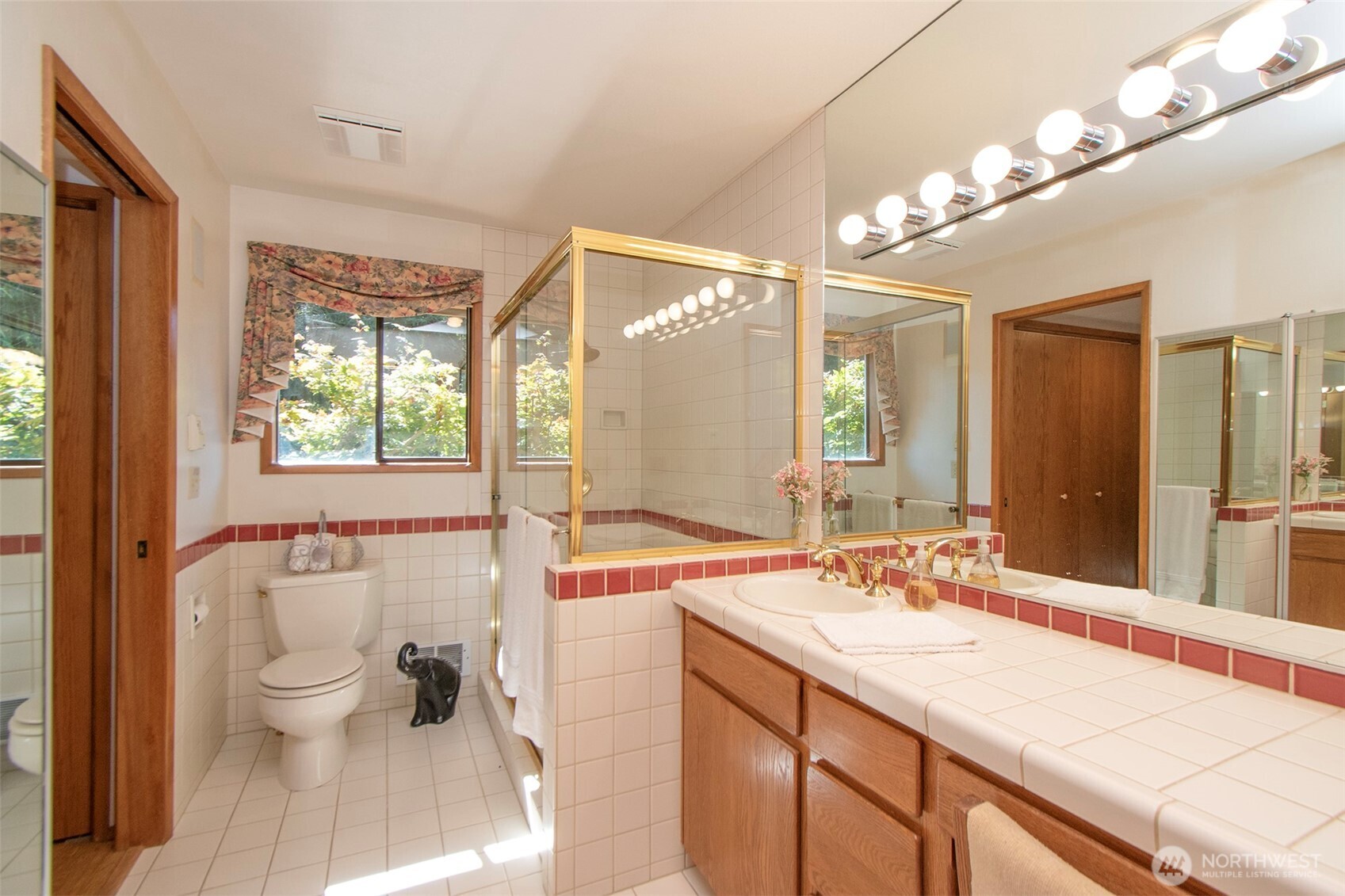 5418 South Old Mill Road Port Angeles, WA 98362 - Photo 19 of 39 a spacious bathroom with a granite countertop sink a large mirror and a toilet