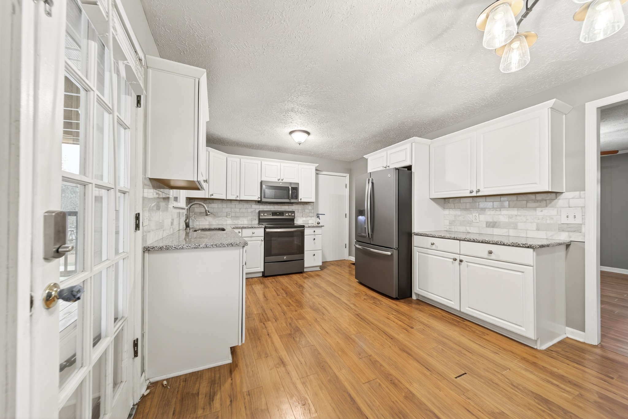 115 Calista Road White House, TN 37188 - Photo 23 of 38 a kitchen with a refrigerator cabinets and wooden floor