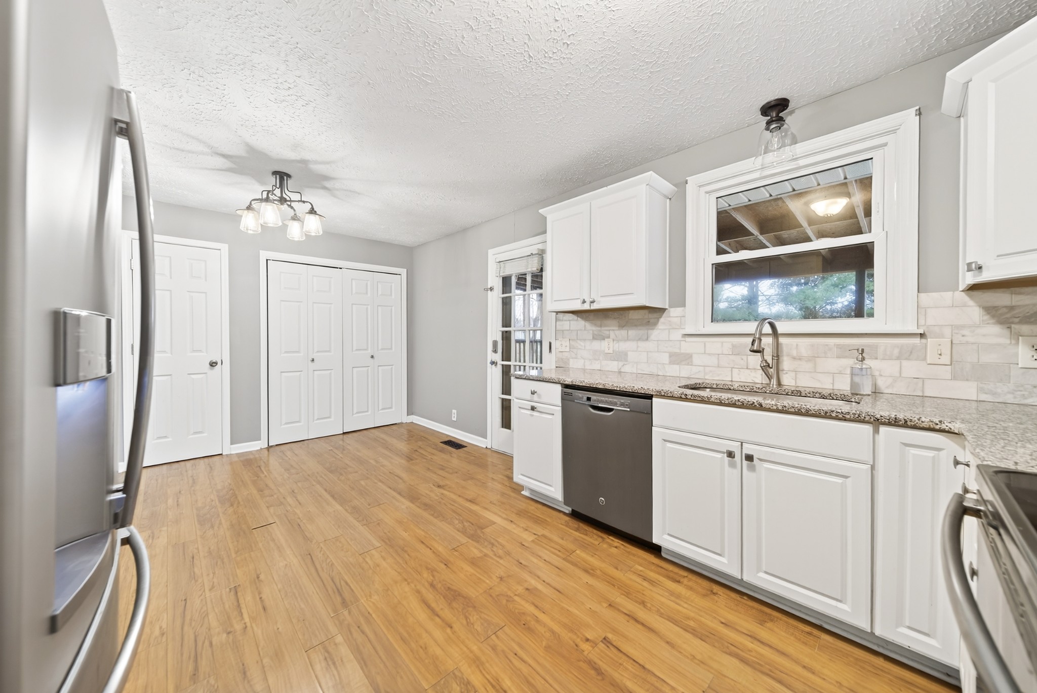 115 Calista Road White House, TN 37188 - Photo 27 of 38 a kitchen with granite countertop a sink cabinets and stainless steel appliances