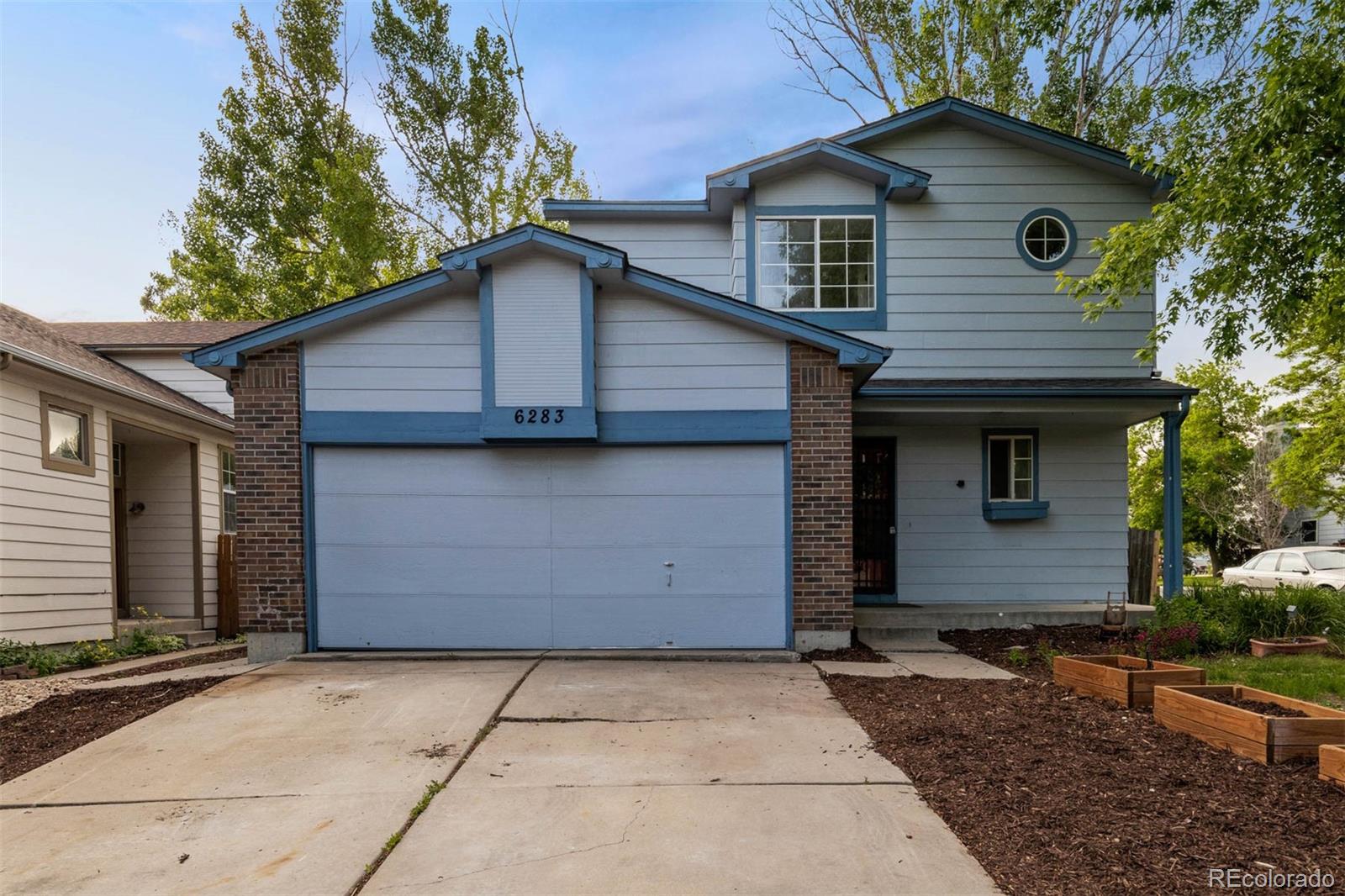6283 Xavier Street Arvada, CO 80003 - Photo 1 of 36 a front view of a house with a yard and garage