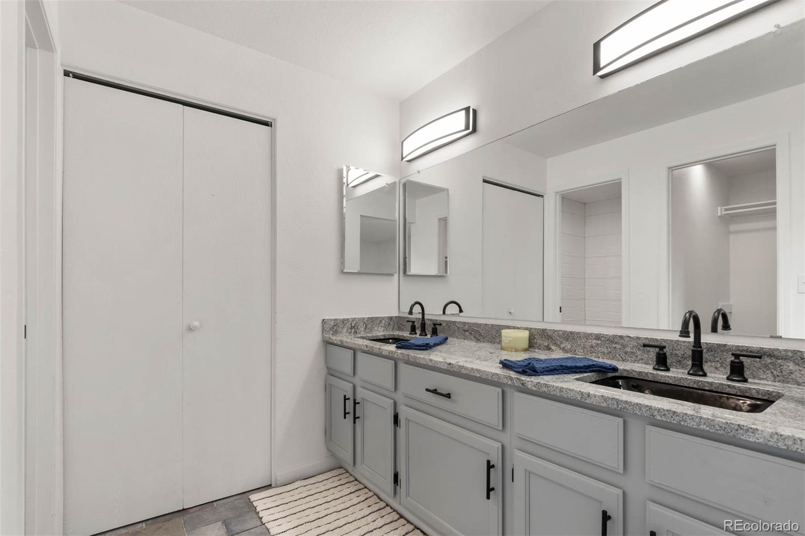 6283 Xavier Street Arvada, CO 80003 - Photo 17 of 36 a bathroom with a double vanity sink and mirror