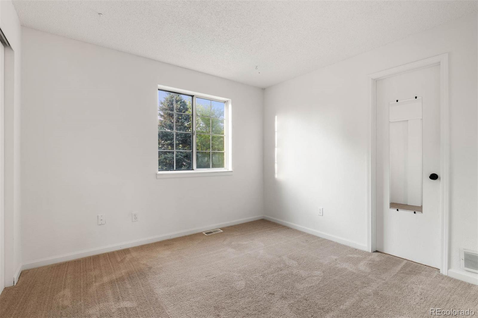 6283 Xavier Street Arvada, CO 80003 - Photo 20 of 36 a view of an empty room with a window