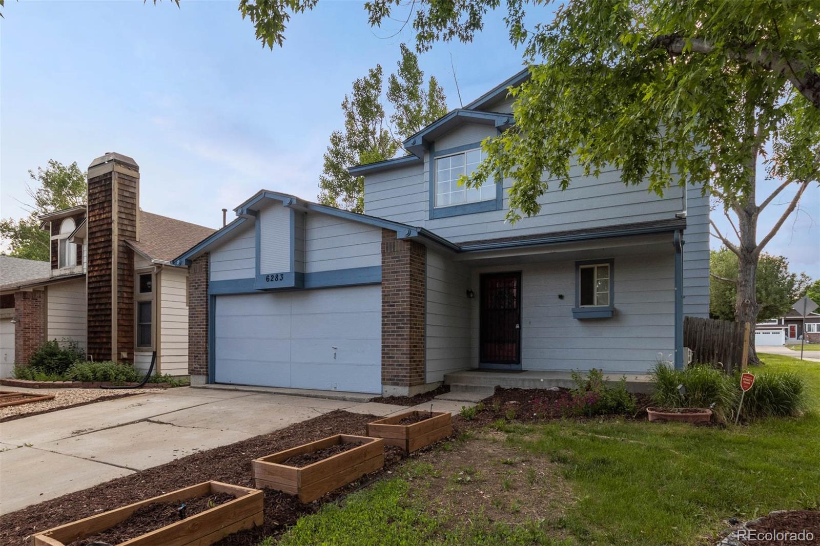 6283 Xavier Street Arvada, CO 80003 - Photo 2 of 36 a front view of a house with garden