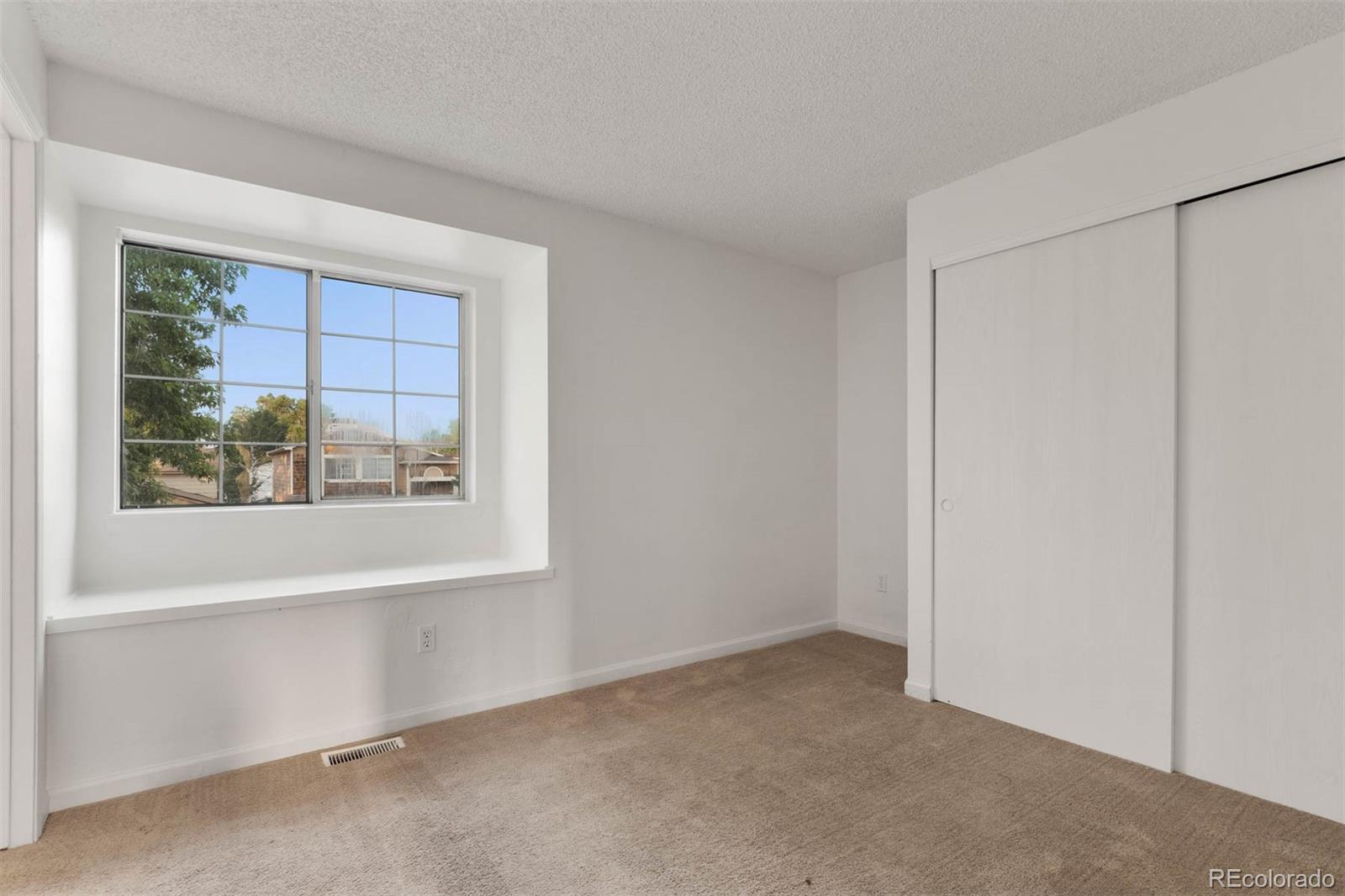 6283 Xavier Street Arvada, CO 80003 - Photo 21 of 36 a view of an empty room with a window