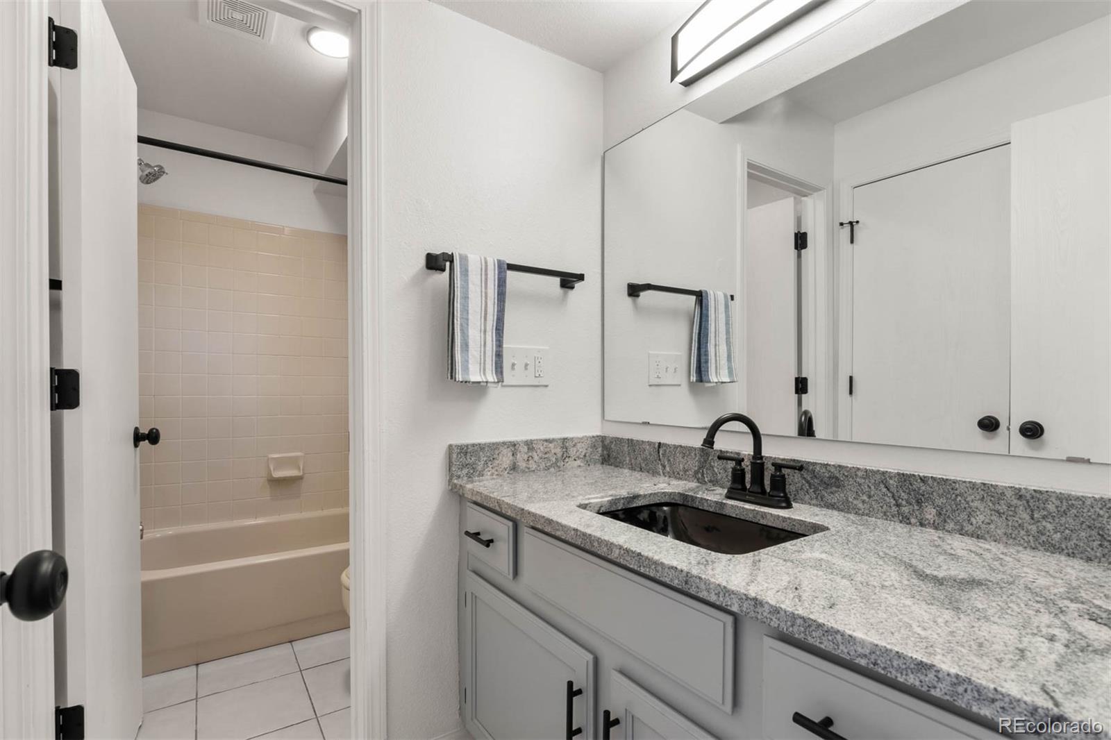 6283 Xavier Street Arvada, CO 80003 - Photo 23 of 36 a bathroom with a sink and a mirror a bathtub