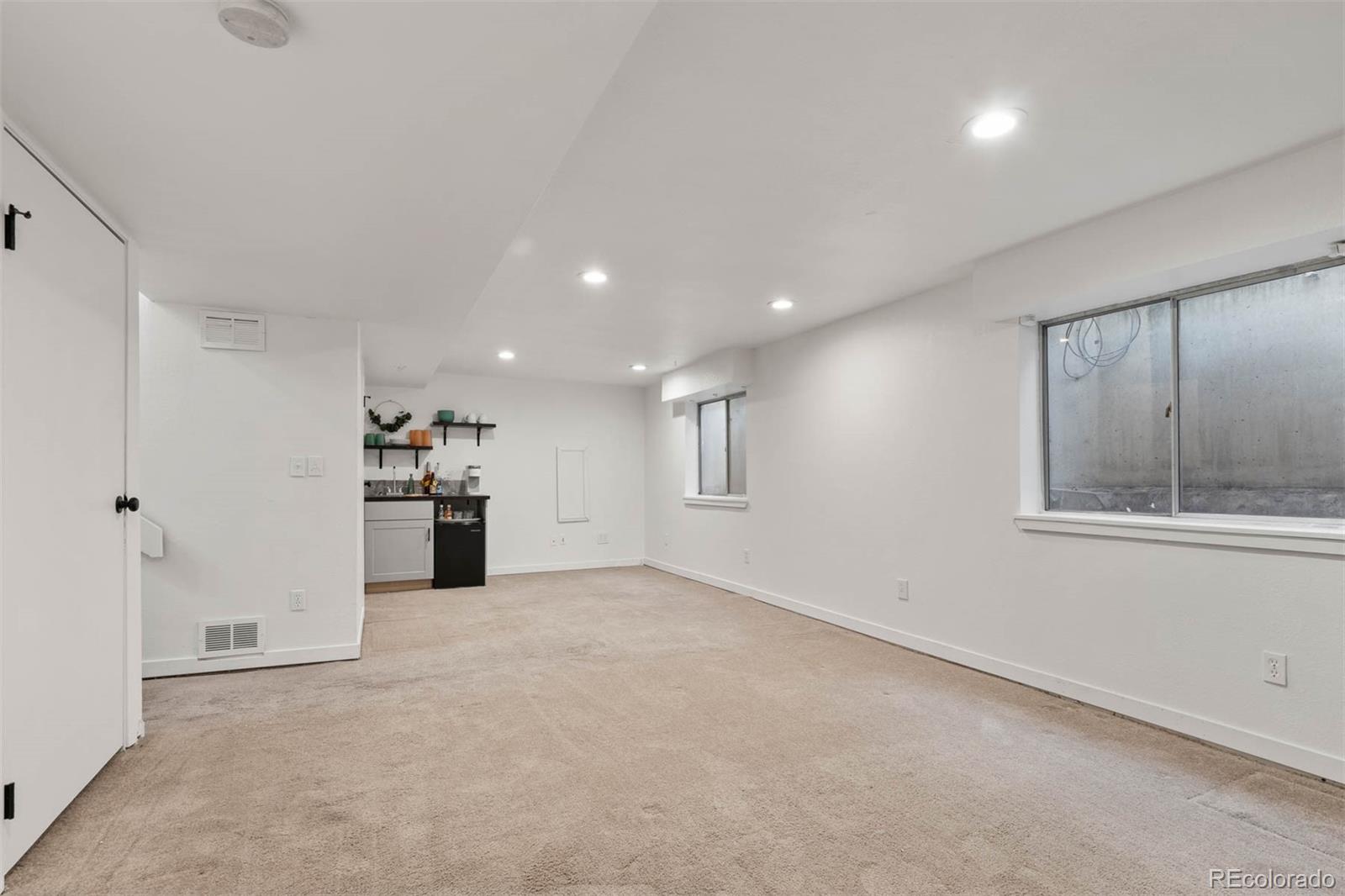 6283 Xavier Street Arvada, CO 80003 - Photo 26 of 36 an empty room with cabinet and windows