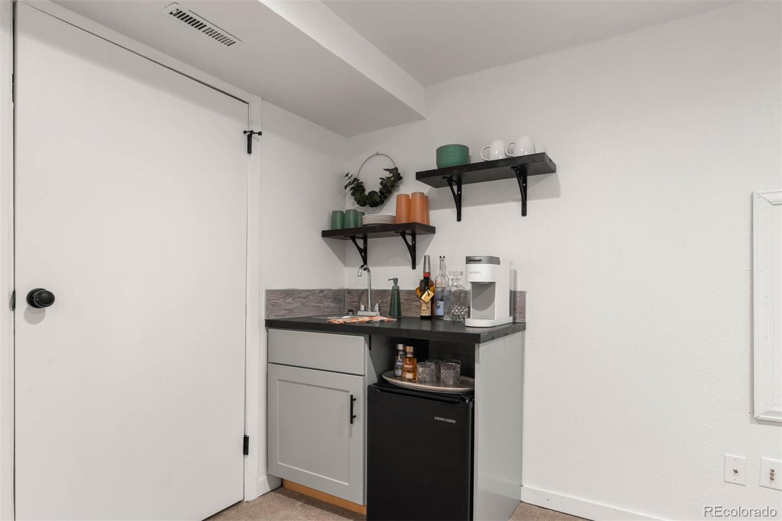 6283 Xavier Street Arvada, CO 80003 - Photo 29 of 36 a kitchen with a sink and cabinets