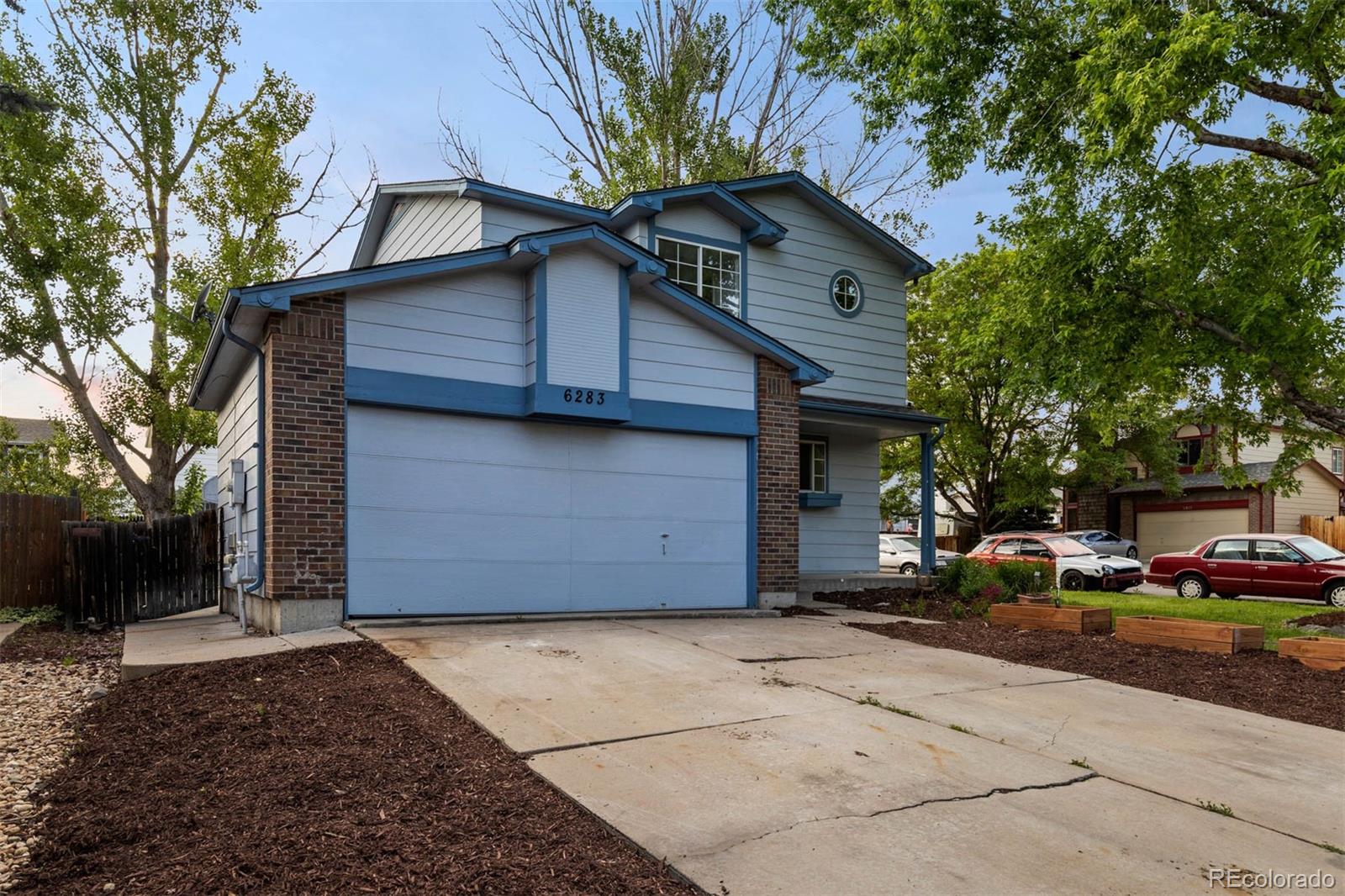 6283 Xavier Street Arvada, CO 80003 - Photo 3 of 36 a front view of a house with a yard