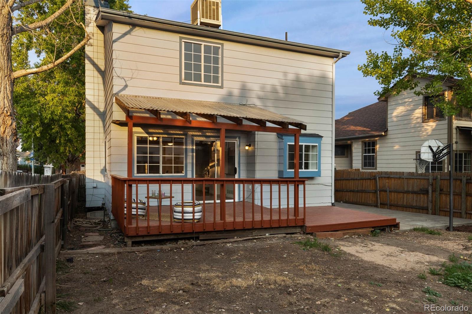 6283 Xavier Street Arvada, CO 80003 - Photo 35 of 36 a view of a house with a wooden deck and a backyard