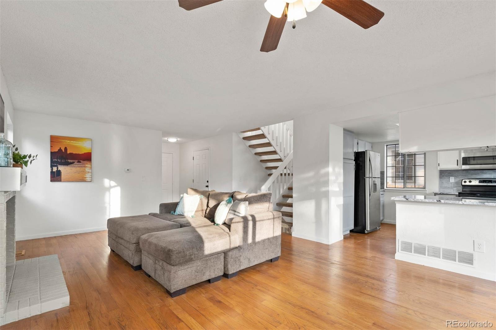 6283 Xavier Street Arvada, CO 80003 - Photo 6 of 36 a living room with furniture and a kitchen view