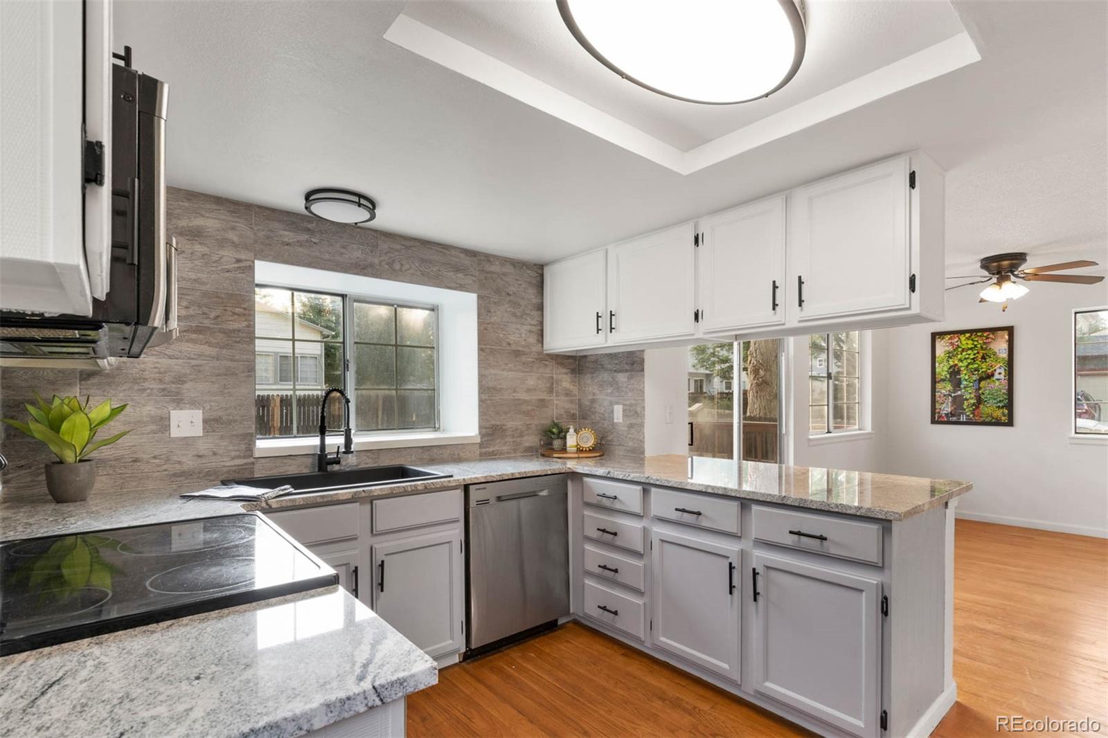 6283 Xavier Street Arvada, CO 80003 - Photo 9 of 36 a kitchen with stainless steel appliances granite countertop a sink stove and cabinets