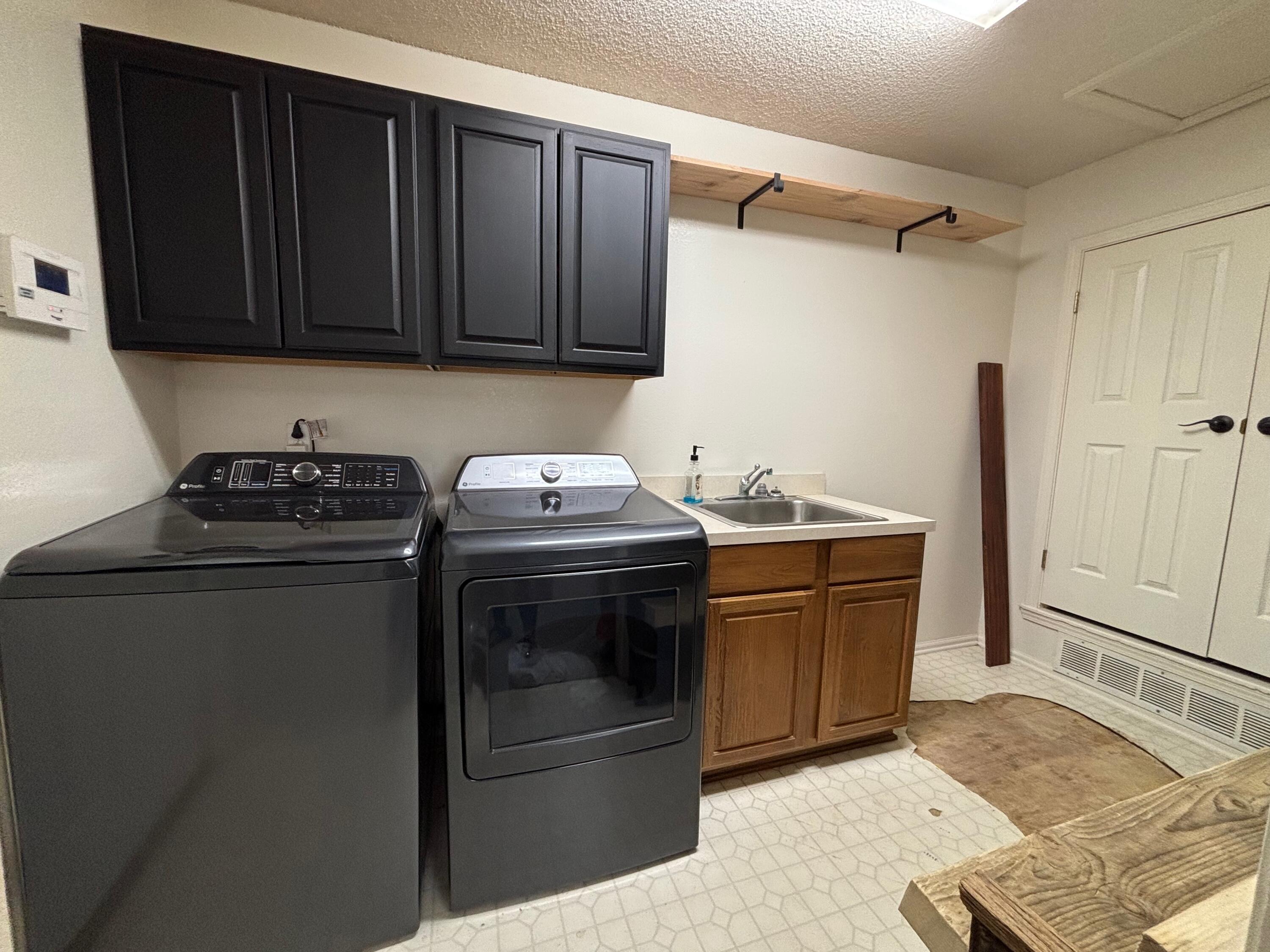 1502 Culpepper Avenue Wilson, TX 79381 - Photo 17 of 26 a kitchen with stainless steel appliances wooden cabinets and a stove top oven