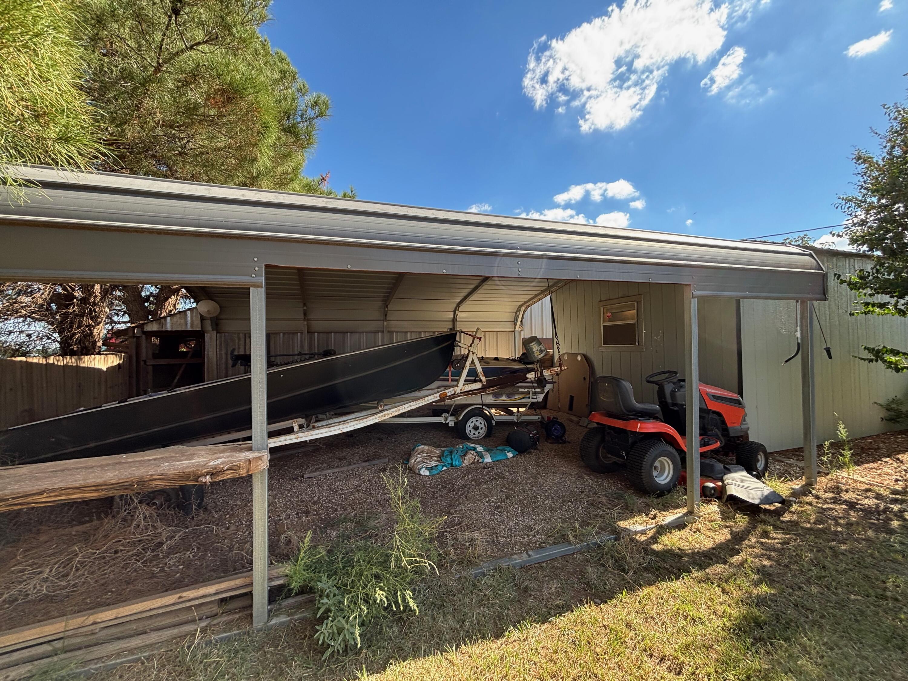 1502 Culpepper Avenue Wilson, TX 79381 - Photo 20 of 26 a view of a garage with a couch and a chandelier