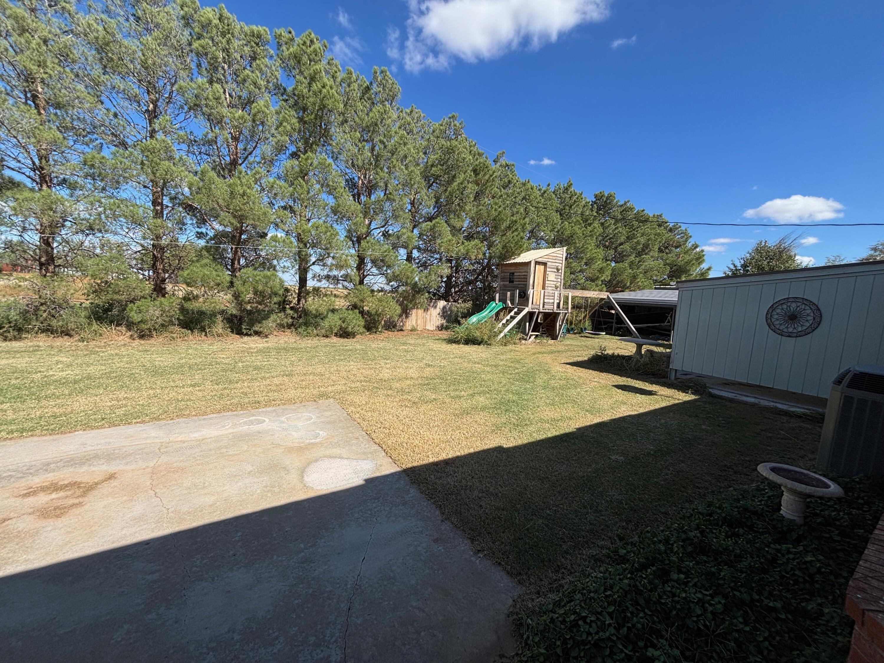 1502 Culpepper Avenue Wilson, TX 79381 - Photo 24 of 26 a view of a swimming pool with an outdoor seating and a yard