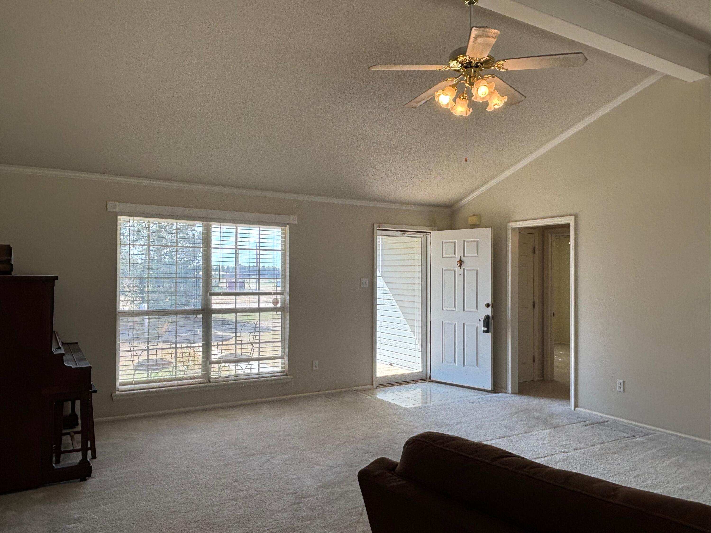 1502 Culpepper Avenue Wilson, TX 79381 - Photo 5 of 26 a bedroom with a bed and a chandelier