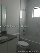 4374 East 10th Avenue, Unit 4374 Hialeah, FL 33013 - Photo 17 of 29 a bathroom with a toilet a sink and shower