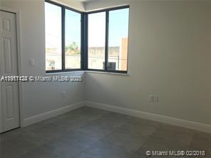 4374 East 10th Avenue, Unit 4374 Hialeah, FL 33013 - Photo 18 of 29 an empty room with a window