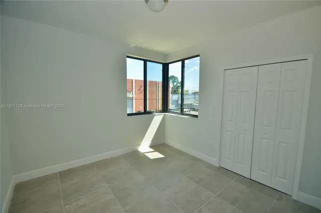 a view of a livingroom with an empty space and window