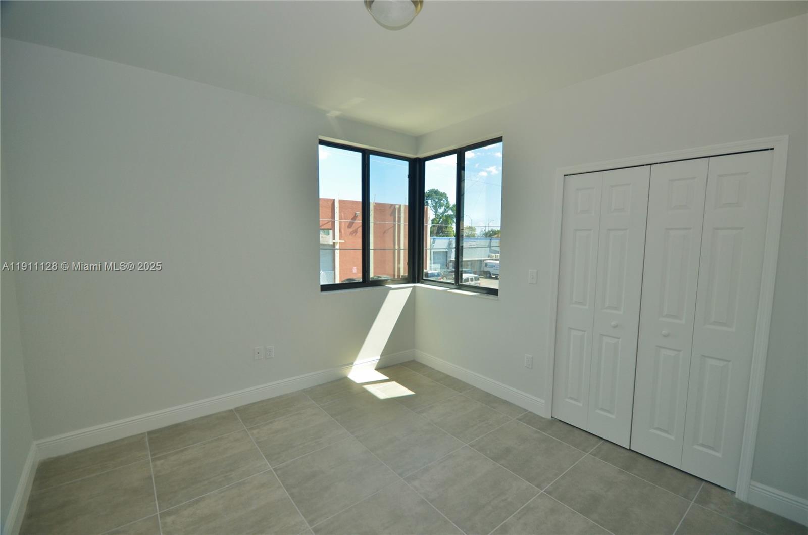 4374 East 10th Avenue, Unit 4374 Hialeah, FL 33013 - Photo 19 of 29 a view of a livingroom with an empty space and window