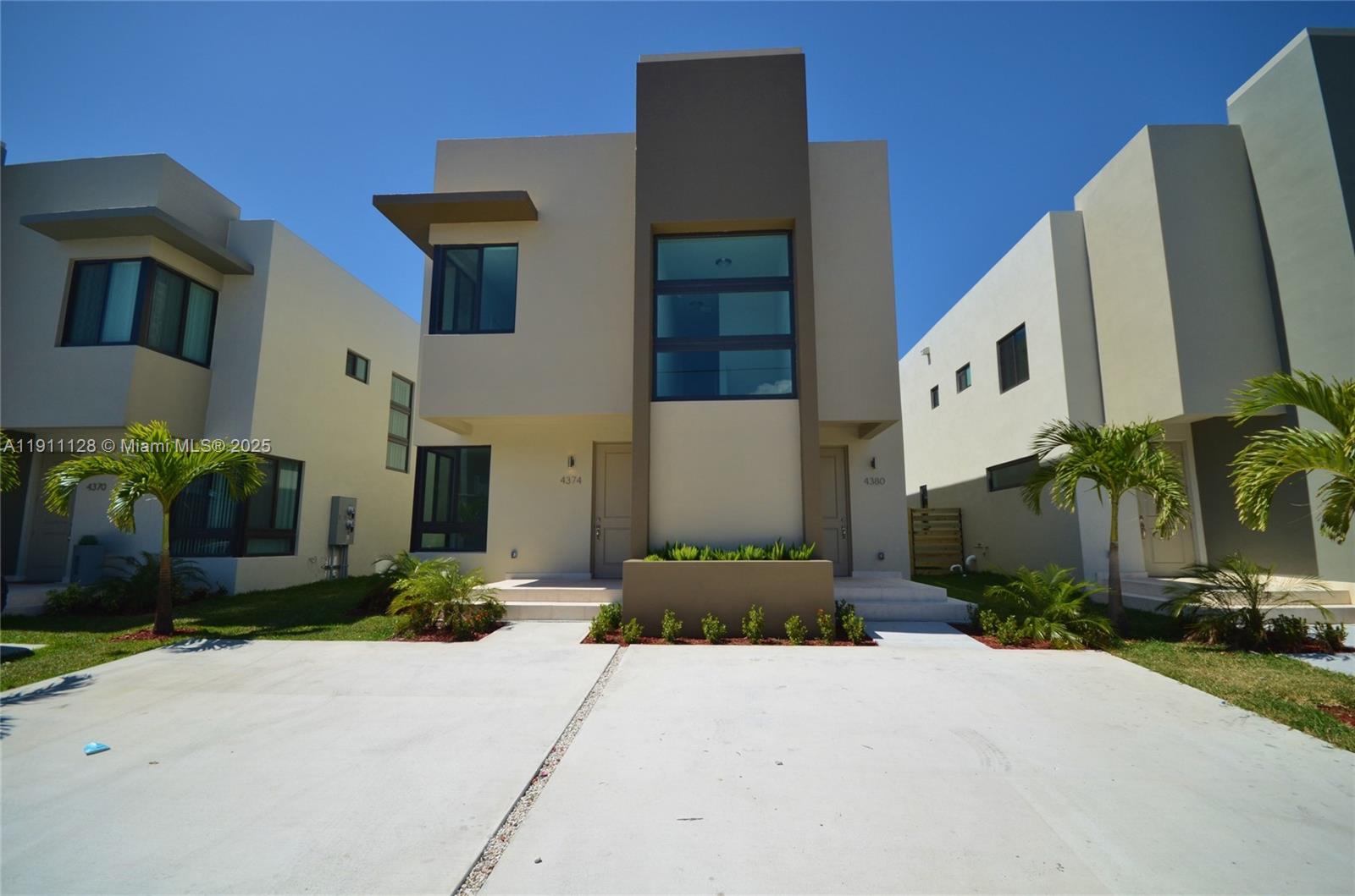 4374 East 10th Avenue, Unit 4374 Hialeah, FL 33013 - Photo 2 of 29 a front view of a house with a yard