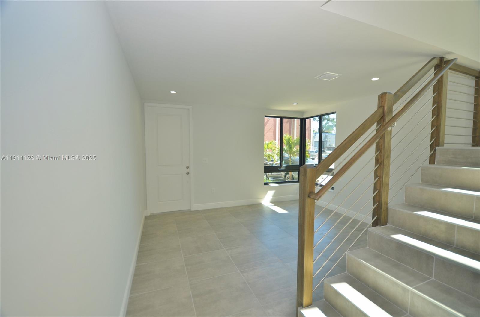 4374 East 10th Avenue, Unit 4374 Hialeah, FL 33013 - Photo 6 of 29 a view of entryway and hall with wooden floor