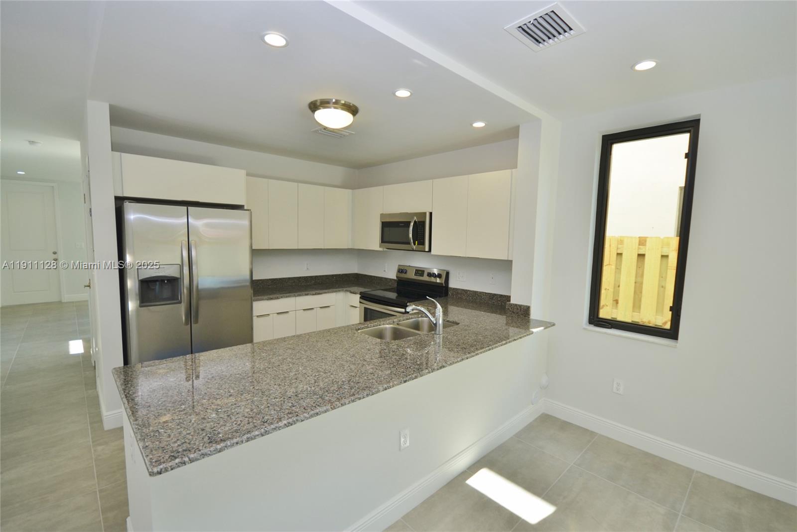 4374 East 10th Avenue, Unit 4374 Hialeah, FL 33013 - Photo 10 of 29 a view of a kitchen with a sink and natural light