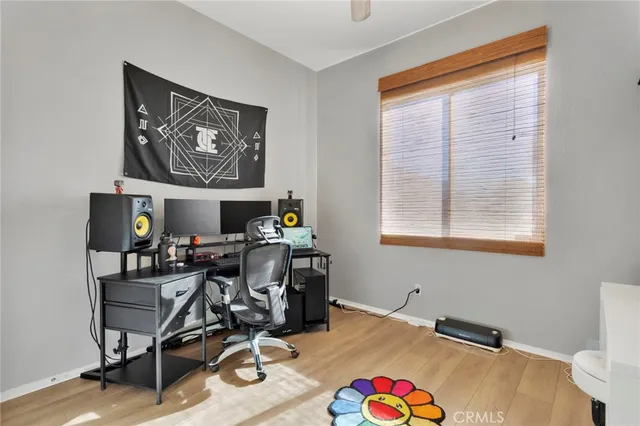 a view of a workspace with furniture and a window