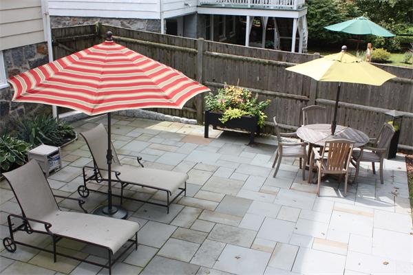 490 Brook Road Milton, MA 02186 - Photo 23 of 24 a backyard of a house with table and chairs under an umbrella
