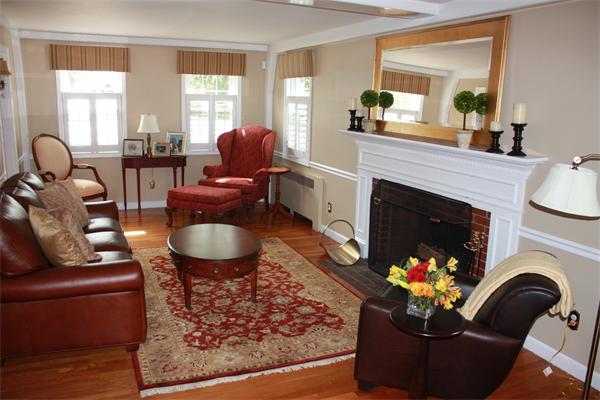 490 Brook Road Milton, MA 02186 - Photo 7 of 24 a living room with furniture a fireplace and a large window