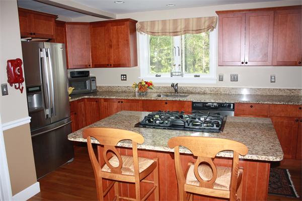 490 Brook Road Milton, MA 02186 - Photo 10 of 24 a kitchen with stainless steel appliances granite countertop a refrigerator a stove a sink and dishwasher with wooden floor