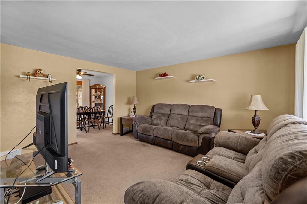 189 William Circle McKees Rocks, PA 15136 - Photo 7 of 24 a living room with furniture a flat screen tv and gym equipment