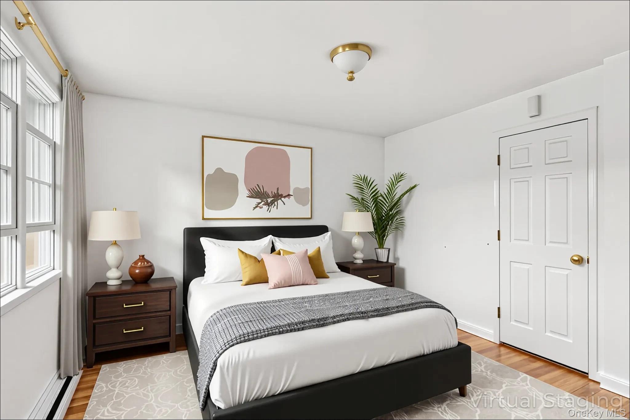 370 Blue Point Road Farmingville, NY 11738 - Photo 9 of 19 Bedroom featuring light wood finished floors and baseboard heating