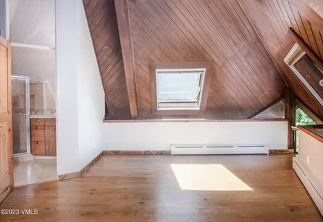 a view of a living room with entryway and wooden floor
