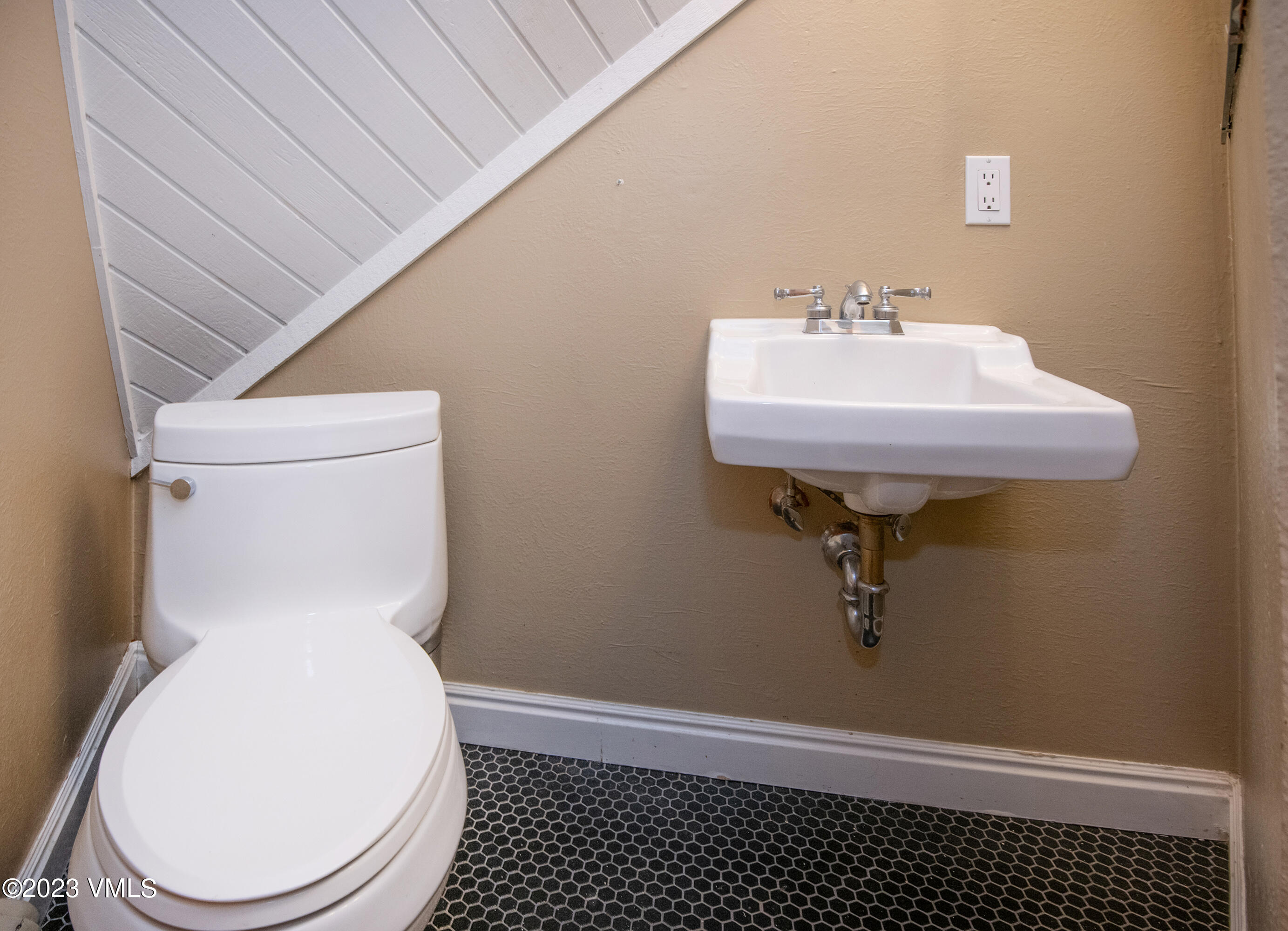 1400 Lions Ridge Loop, Unit A5 Vail, CO 81657 - Photo 27 of 32 a bathroom with a sink toilet and a vanity