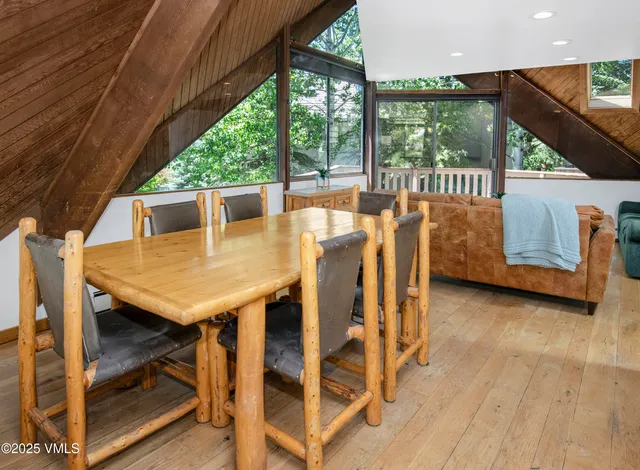 a view of a patio with table and chairs with wooden floor and fence