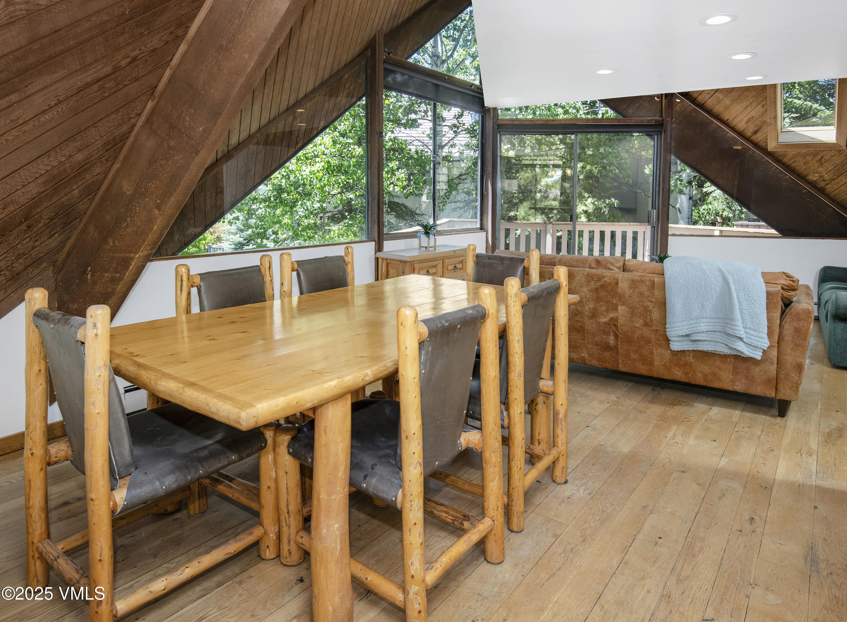 1400 Lions Ridge Loop, Unit A5 Vail, CO 81657 - Photo 8 of 32 a view of a patio with table and chairs with wooden floor and fence